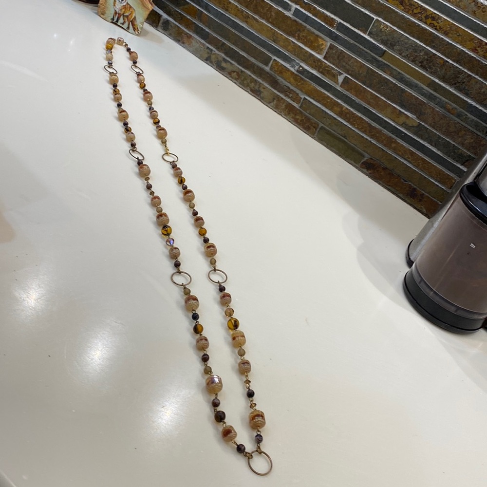 Glass & resin beaded necklace with brass circles to link the beads. Brown,tan